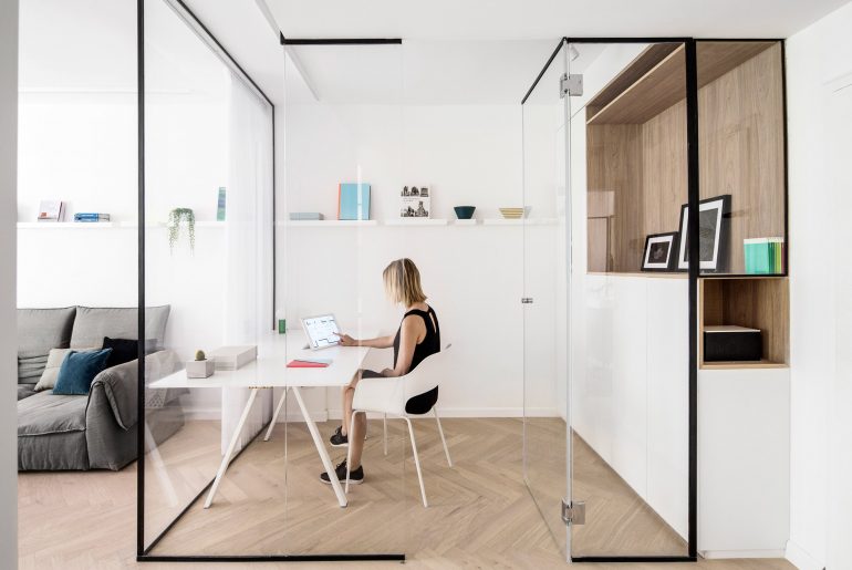 Deze glazen kamer in de woonkamer is ingericht als thuiskantoor