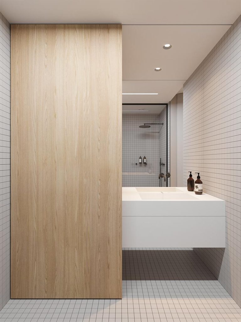 Emil Dervish bedacht dit innovatieve idee in een kleine badkamer. De houten inbouwkast is voorzien van een schuifdeur, die langs de zwevende badkamermeubel openschuift.