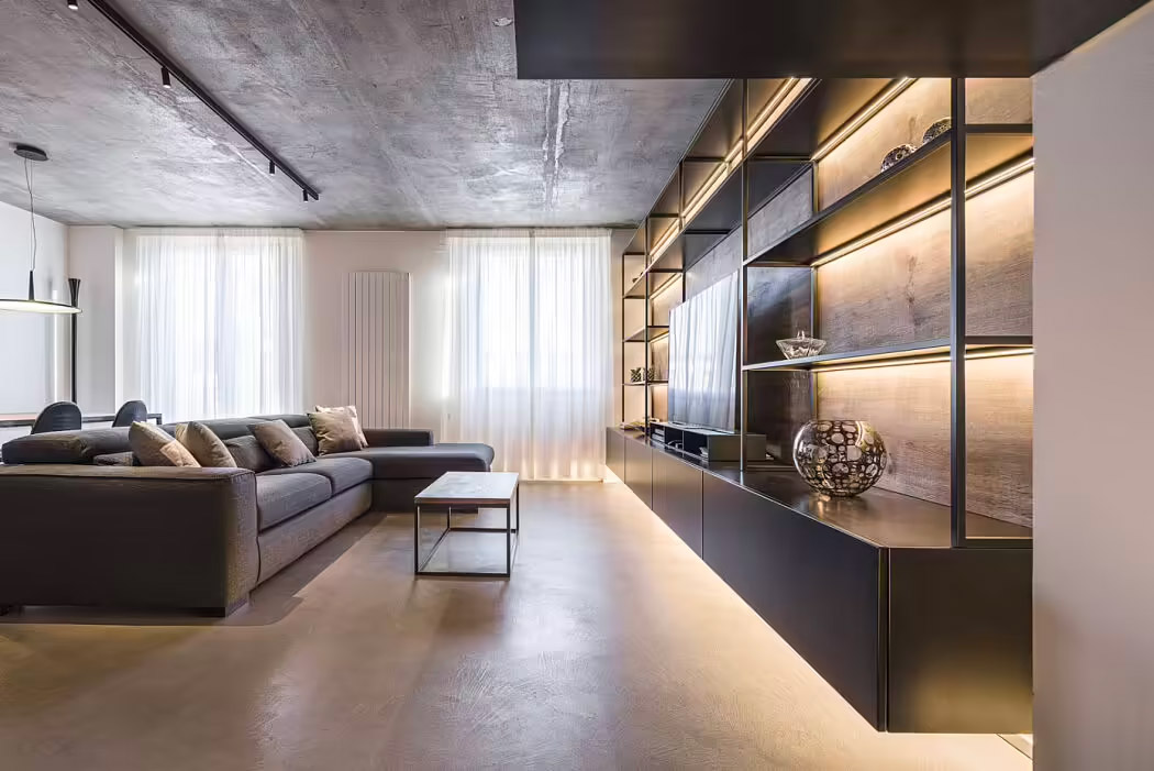 Deze stoere woonkamer is een ontwerp van CMT Architetti, met onder andere een grote op maat gemaakte stalen TV wandkast, en een stalen salontafel.