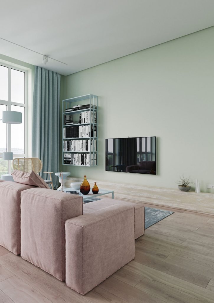 In deze woonkamer zijn verschillende pastelkleuren gecombineerd, met onder andere een groene muur, roze bank en blauwe gordijnen. De houten vloer staat er super mooi bij.