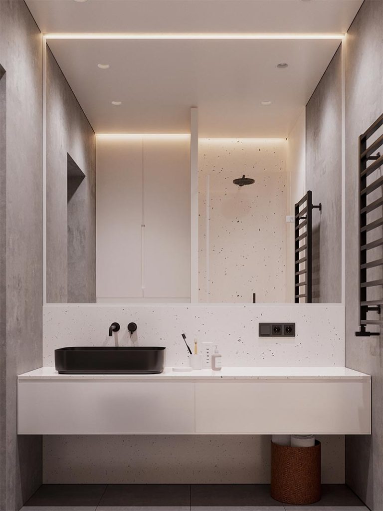 Daartegenover vond je een zwevende badkamermeubel op maat, in combinatie met een grote spiegelwand op maat.